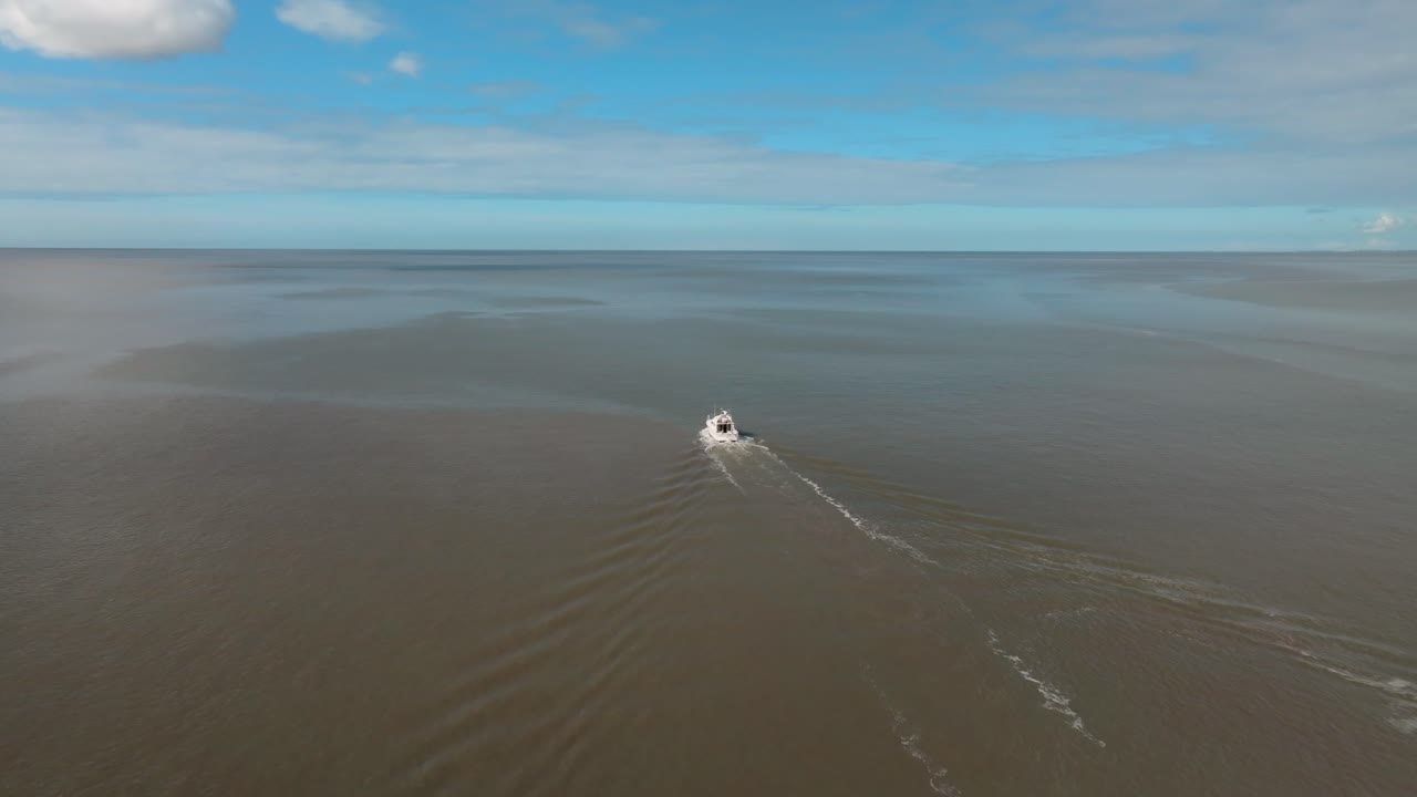 Lone Small Craft In Wide Open Calm Sea Waters On Sunny Day With Camera Slow Descent. Fleetwood, Lancashire, UK