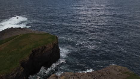 Aerial-View-of-Ocean-Waves-Breaking-on-Scenic-Coastline-of-Ireland,-Steep-Cliffs-Near-Kilkee,-Drone-Shot