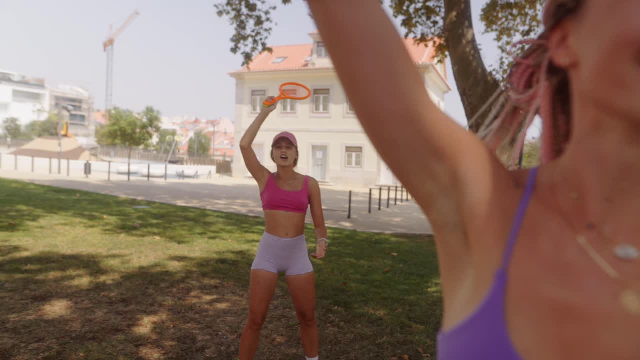 Women Playing Tennis in Park