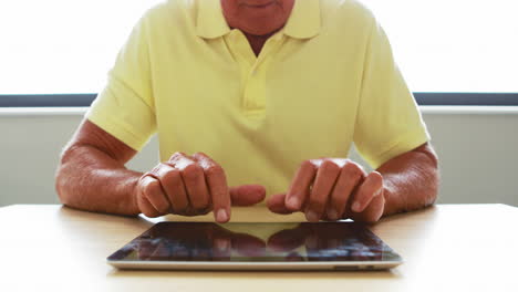 close up view of senior man using tablet computer