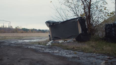 a couch and other unnecessary items were dumped under a bridge a short distance from a coal-fired power plant