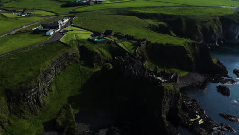 aerial pan left shot of the dunluce castle from afar