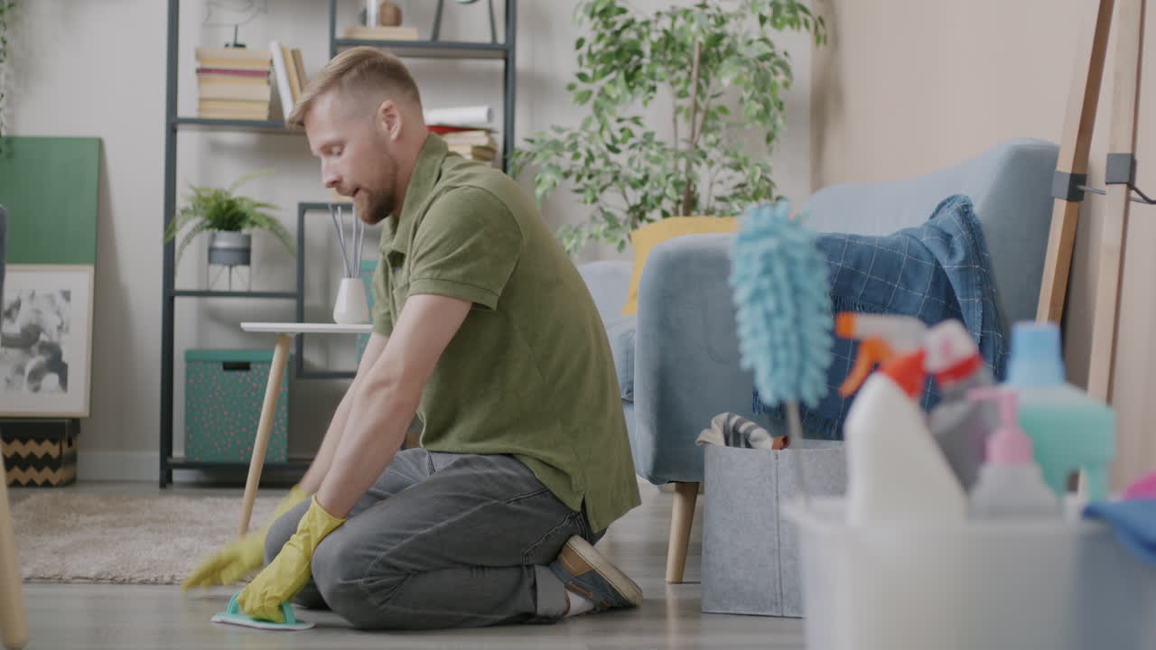Man Cleaning the Floor in a Living Room