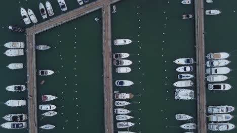 aerial birds eye shot of yachts and speedboats parking in port area