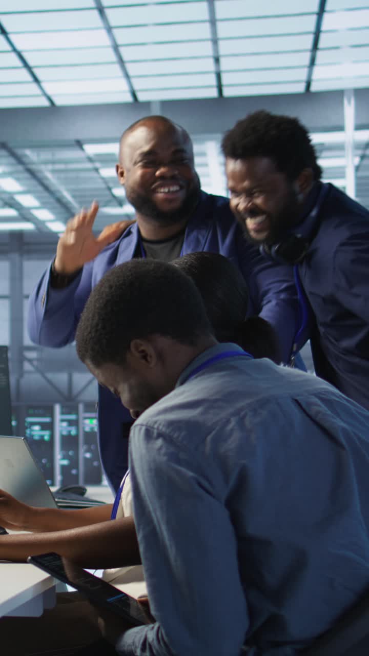 Vertical video Data center coworkers laughing, having fun