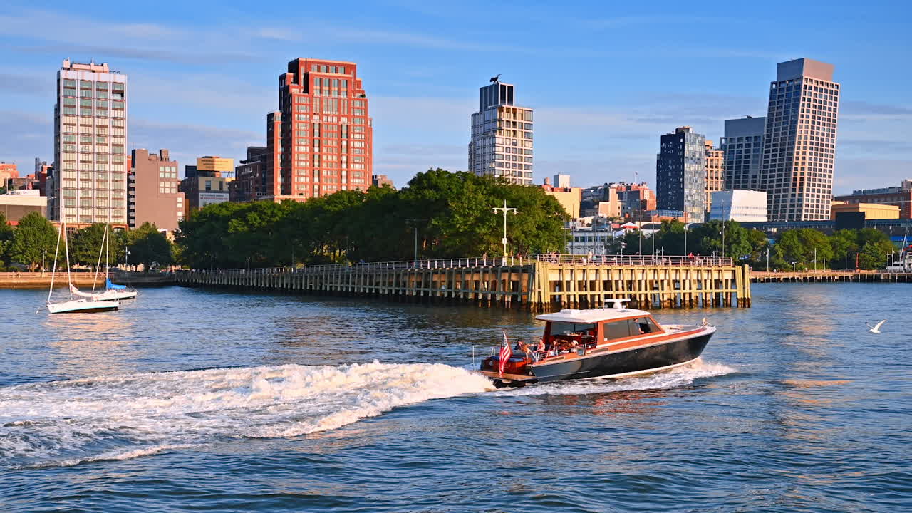 New York, USA, 4 August 2025: Speedboat on Hudson River with Chelsea Piers in background. A speedboat moving on the Hudson River with Chelsea Piers waterfront