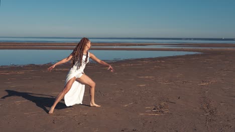 young woman dancing on beach