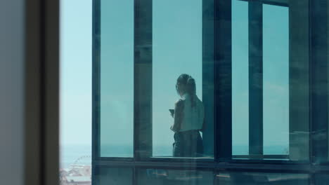 successful asian business woman looking out window proud ceo planning ahead thinking of ideas for future investment strategy corporate manager enjoying leadership career in office