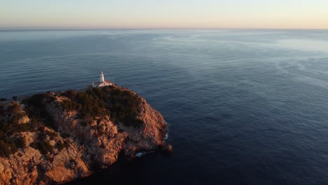 sunrise view of lighthouse next to sea