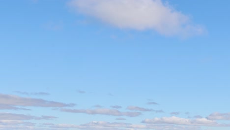 clouds drift gently in a clear sky