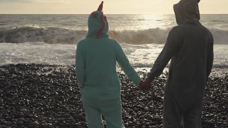 couple in pajamas on the beach at sunset