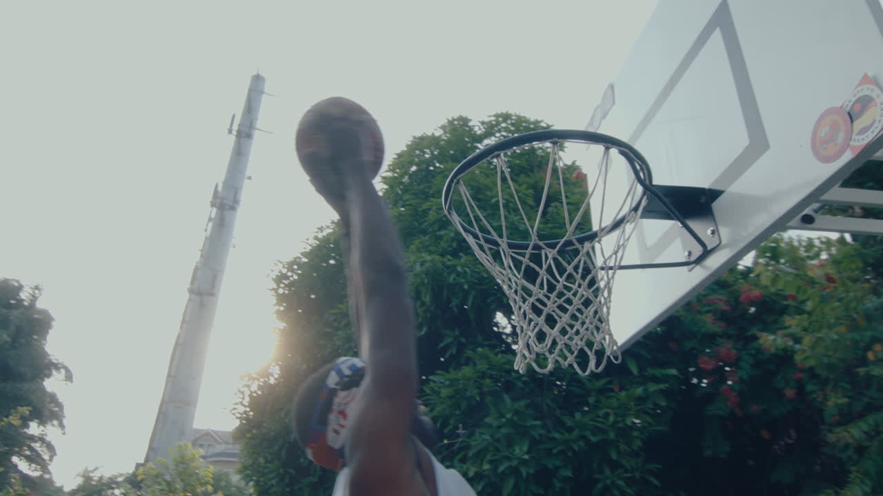 Hoop on Outdoor Basketball Court, Player Shooting a Ball and Scoring