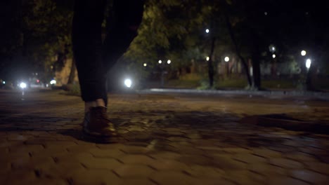 person walking at night on a city street