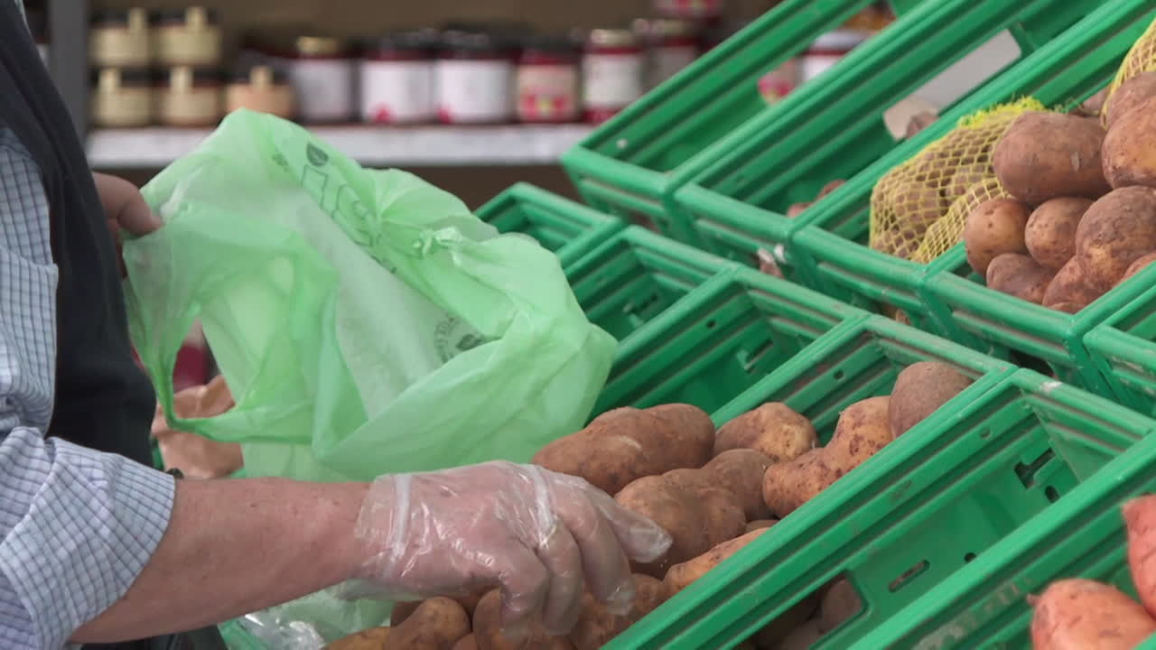 Person shopping for potatoes in a grocery store