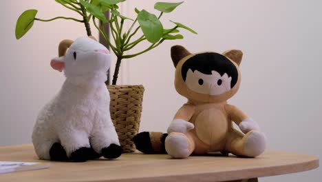 slow orbiting shot of small animal soft toys sitting on a coffee table