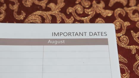 notebook concept positioning text 'important dates' reveal shot