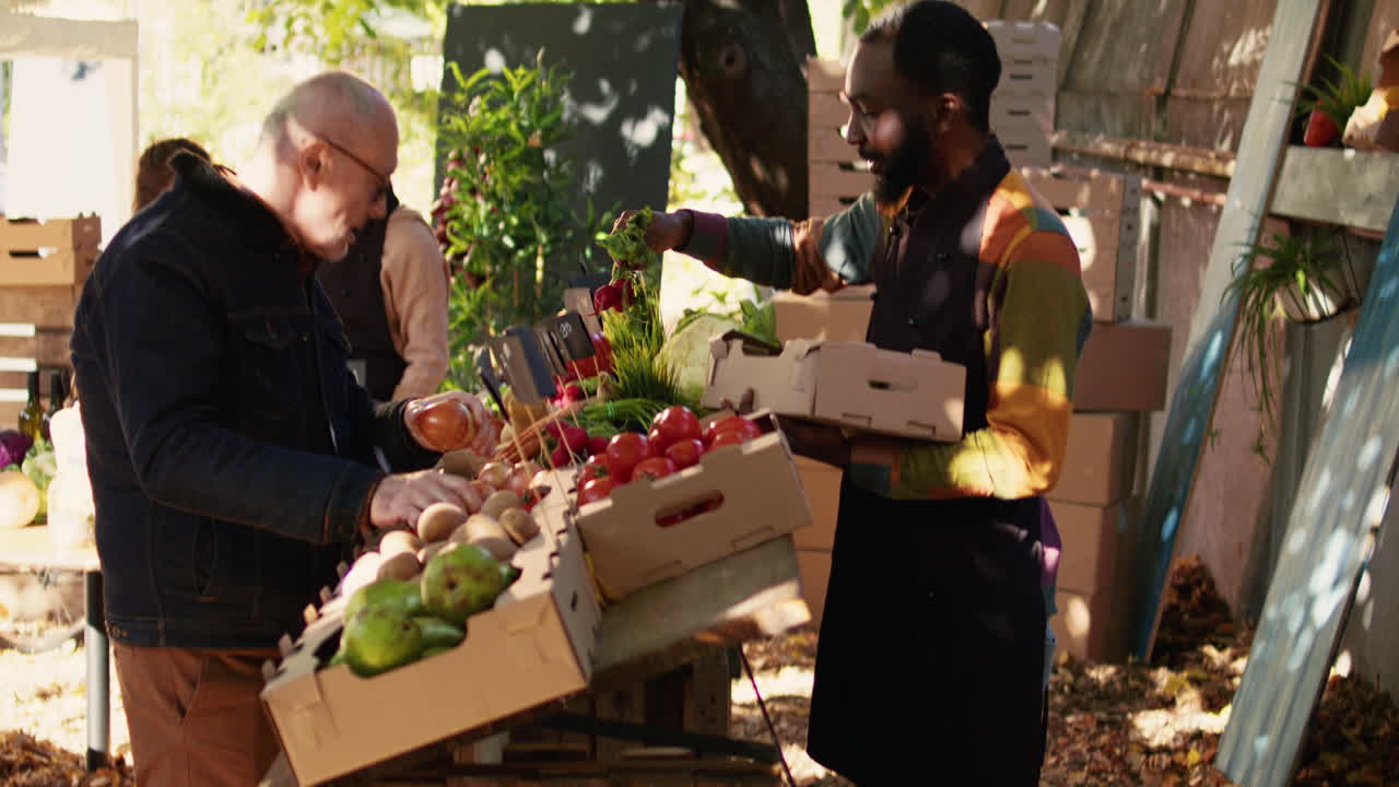 People buying and selling fresh produce at a farmers market