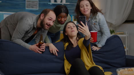 Multiracial-friends-speaking-with-collegue-man-during-video-call-conference