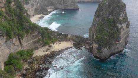 aerial view of a brave tourist standing on the edge of the cliff