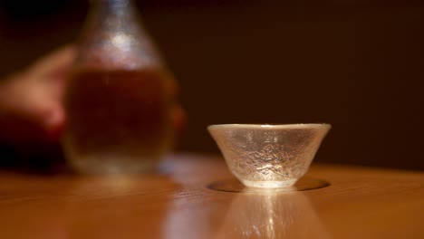 sequential sake serving into a glass cup