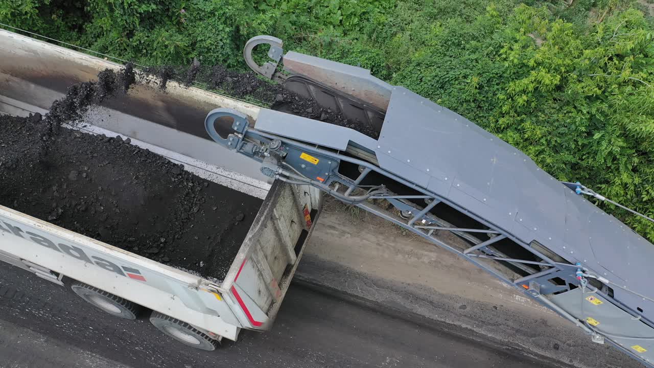 Roadwork on asphalt replacement. Special equipment for laying new asphalt on the road in the countryside. Aerial view.
