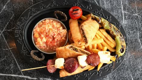 turkish food plate with sausage, cheese, eggs, and french fries