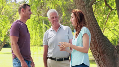 Happy-grandfather-speaking-with-father-and-mother