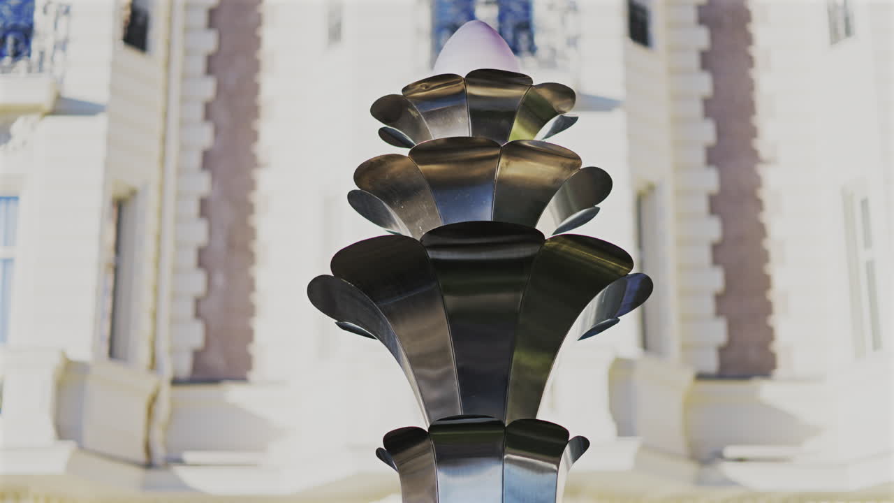 Metal Sculpture with a blurred background of a building in the south of France