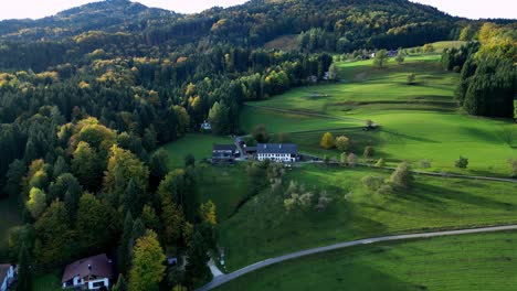 Aerial-view-of-a-vibrant-green-farm-nestled-in-a-lush-valley