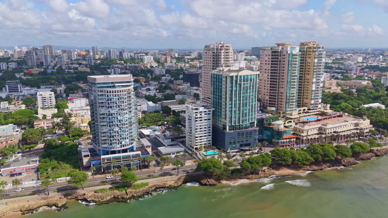 Skyscrapers on Avenida George Washington in Santo Domingo, Dominican Republic. Pan right to left, drone aerial