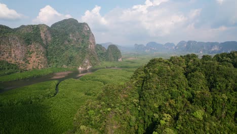 Drone-flying-over-large-mountains-surrounded-by-rivers-and-mangroves-in-Ao-Thalane-Krabi-Thailand-on-a-sunny-day