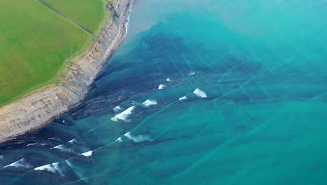 waves crashing against the shore - ariel drone shot