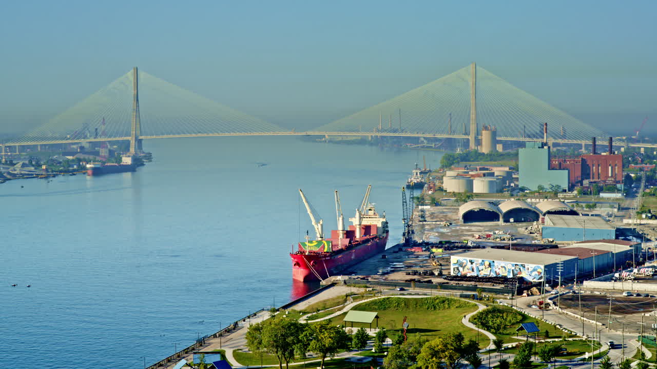 Epic drone flyover of Detroit River featuring a freighter cutting through the water with skyline backdrop