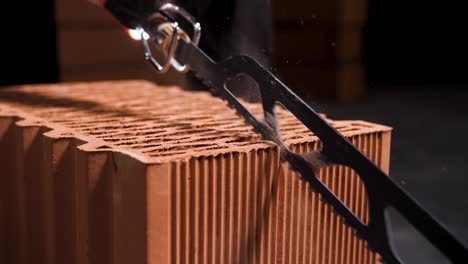 cutting a brick with a saw