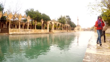 some tourists walk near balikligol pool of sacred fish winter view sanliurfa