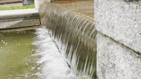 water flows down a fountain in a small waterfall