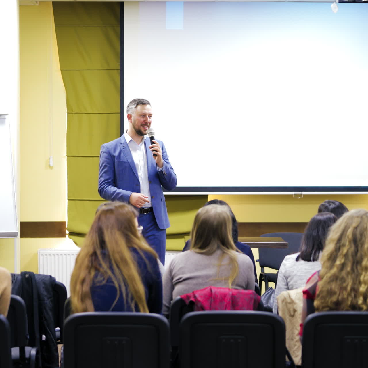 Speaker at a business training conference. Audience at the conference hall. Entrepreneurship club