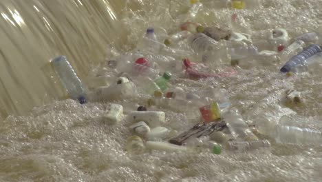 piles of garbage plastic bottle floating and gathering together near a small waterfall