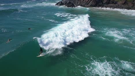 surfer over sea waves in cabarita beach in northern rivers coastline, new south wales, australia