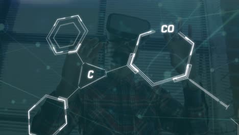 Animation-of-chemical-structures-over-biracial-man-wearing-vr-headset-at-office