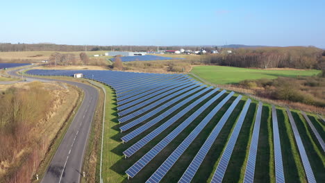 a drone flies over a huge solar park consisting of many solar panels