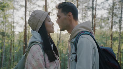 couple kissing in a forest