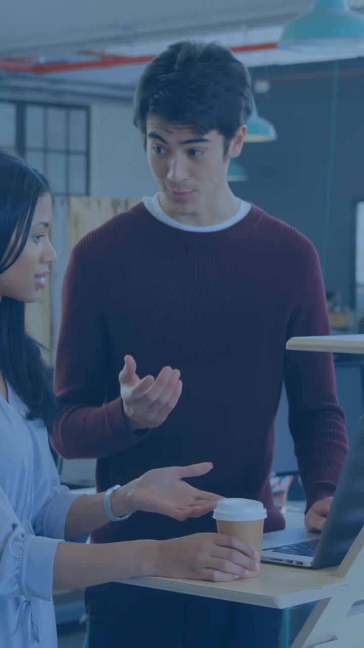 Vertical video: Team tapping laptop, reviewing UI as rings expanding overlaying team in business