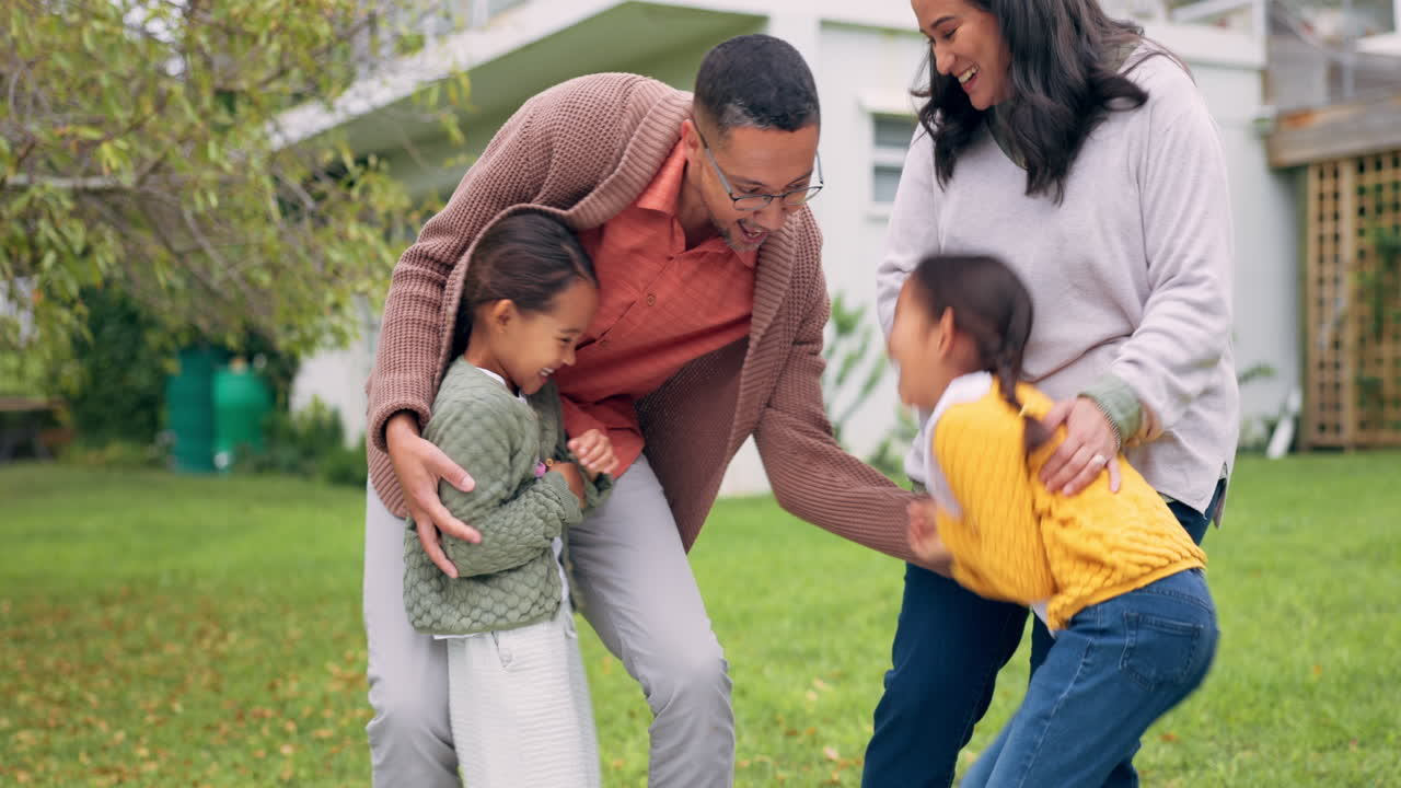 Family, tickle and playing outdoor in a backyard