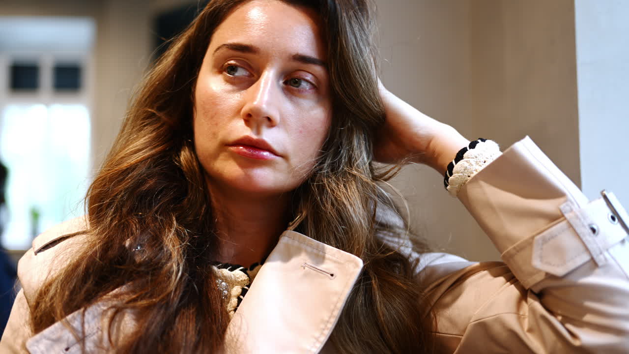 Pensive woman waiting and looking around in a cafe