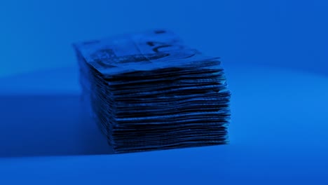 stylized slow motion euro money shot in cold light suggesting financial power