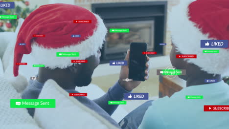social media notifications animation over people wearing santa hats and using smartphone