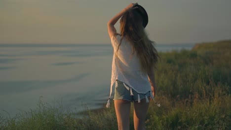 woman enjoying a sunset by the river