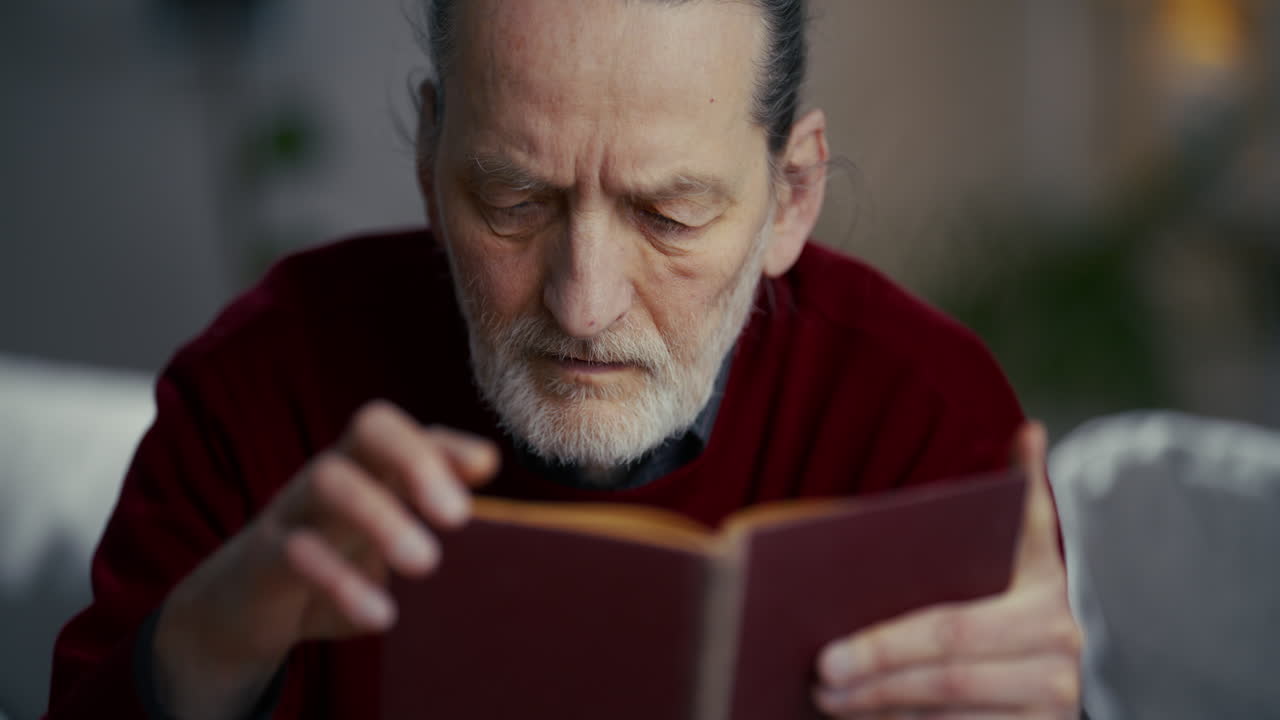 Close-up of an Elderly Man Reading a Book