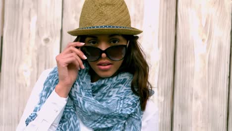 hipster posing against wooden fence